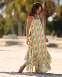 Model walking on the beach wearing the RIVA SOLARE resort dress