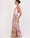 Model walking wearing floral wrap skirt cover up showing movement and slit detail