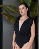 CAPRI black one-piece swimsuit with deep V neckline and elegant draped bodice