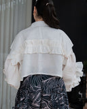 Back view of structured cotton blouse with ruffle detailing – ECLAT