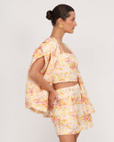 Side view of floral linen crop top with structured fit and lightweight fabric resort styling