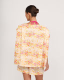 Back view of floral linen shorts with relaxed tailored fit and soft pleating detail
