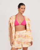 High-waisted floral linen shorts styled with fuchsia bikini and matching blazer, front view resort outfit