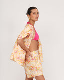 Side view of floral linen tailored shorts with relaxed fit and high waist resort styling