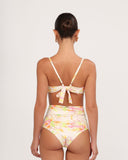 Woman wearing a floral swimsuit with a white background