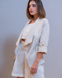 Side view of Scalea linen blazer in white with soft drape and adjustable sleeves

