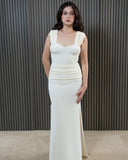 Model wearing the SORRENTO textured lycra skirt in ivory with elegant draped waist and front slit, styled as a refined resort cover-up.